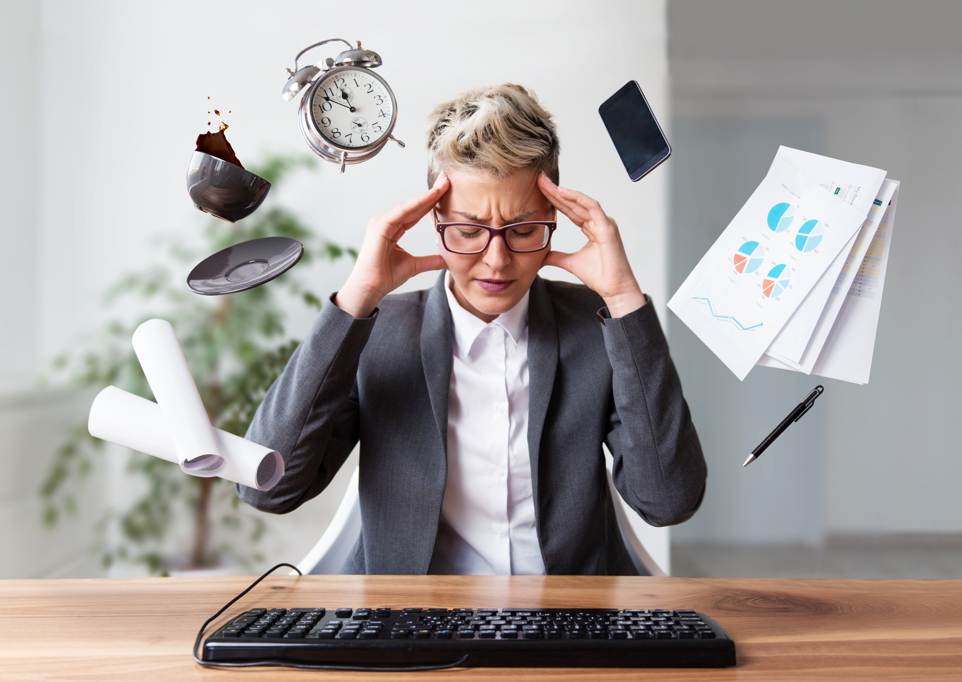 Businesswoman working on a laptop, under pressure